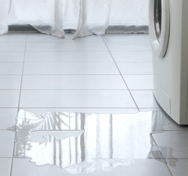 A water damage crisis at a home caused by a leaking washing machine